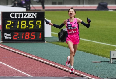 Honami Maeda crosses the finish line in a national record of 2 hours, 18 minutes and 59 seconds on Sunday in Osaka. 