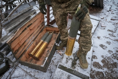 A Ukrainian serviceman prepares shells to fire a howitzer toward Russian troops, at a position near Bakhmut in Donetsk region, Ukraine, on Jan 25.