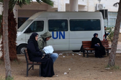 Displaced Palestinian people sit on benches as they wait outside a clinic of the United Nations Relief and Works Agency for Palestine Refugees (UNRWA) in Rafah in the southern Gaza Strip on Sunday. 
