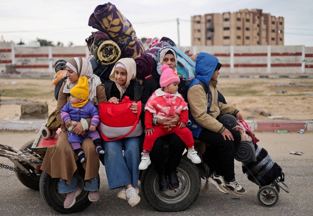 Palestinians fleeing Khan Younis, due to the Israeli ground operation, move toward Rafah, in the southern Gaza Strip, on Sunday.