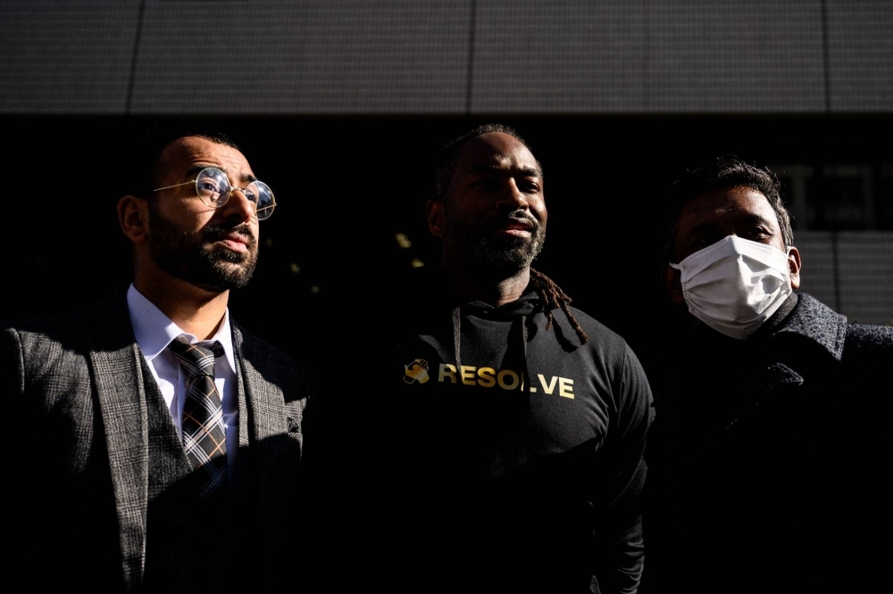 Zain Syed (left), a Pakistan-born Japanese citizen; Maurice, a U.S. citizen with permanent residency in Japan; and Matthew, a Pacific Islander with permanent residency, outside the Tokyo District Court in Tokyo on Monday