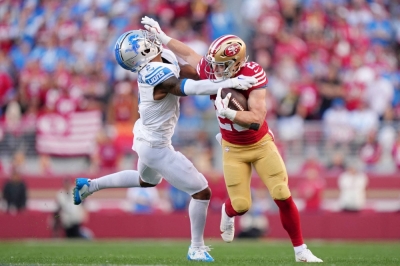 Niners running back Christian McCaffrey (right) stiff arms Lions safety C.J. Gardner-Johnson during the first half of the NFC title game in Santa Clara, California, on Sunday. 