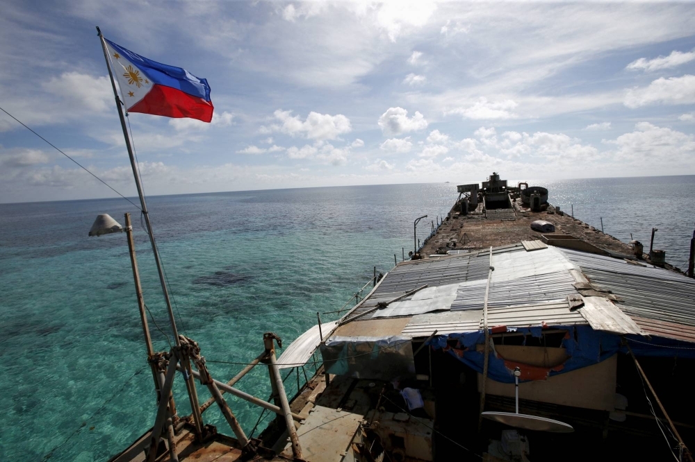 A Philippine flag flutters from BRP Sierra Madre, a dilapidated Philippine Navy ship that has been aground since 1999 and become a Philippine military detachment on the disputed Second Thomas Shoal, part of the Spratly Islands, in the South China Sea in March 2014.