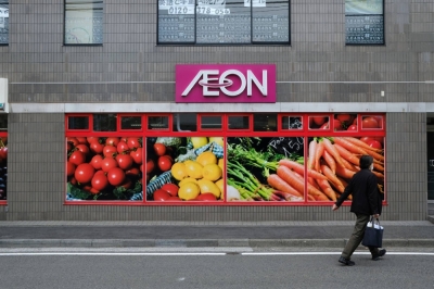 A pedestrian walks outside an Aeon store near Kofukuji Matsubara shopping street in Yokohama in April 2022.