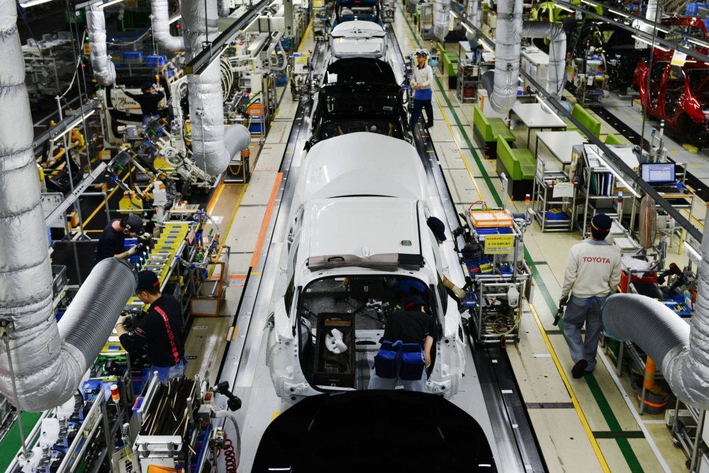 Workers assemble vehicles at Toyota's Tsutsumi plant in Toyota, Aichi Prefecture.