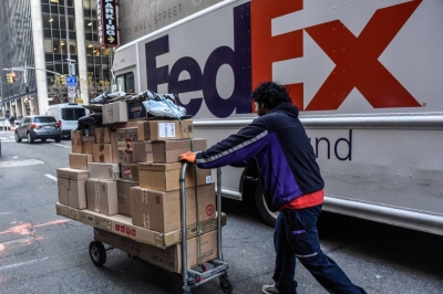 A driver for an independent contractor to FedEx delivers packages on Cyber Monday in New York on Nov. 27, 2023.