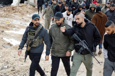Gunmen attend the funeral of three Palestinians killed during an Israeli raid in a hospital, in Jenin, West Bank, on Jan. 30.