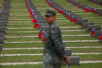 A soldier stands in front of the grave sites of fallen soldiers in Kinmen, Taiwan, on Aug. 23, 2023. Chinese President Xi Jinping has ordered his military to be ready to take Taiwan by 2027, though many analysts see that as an attempt to galvanize his military rather than a timeline for invasion.