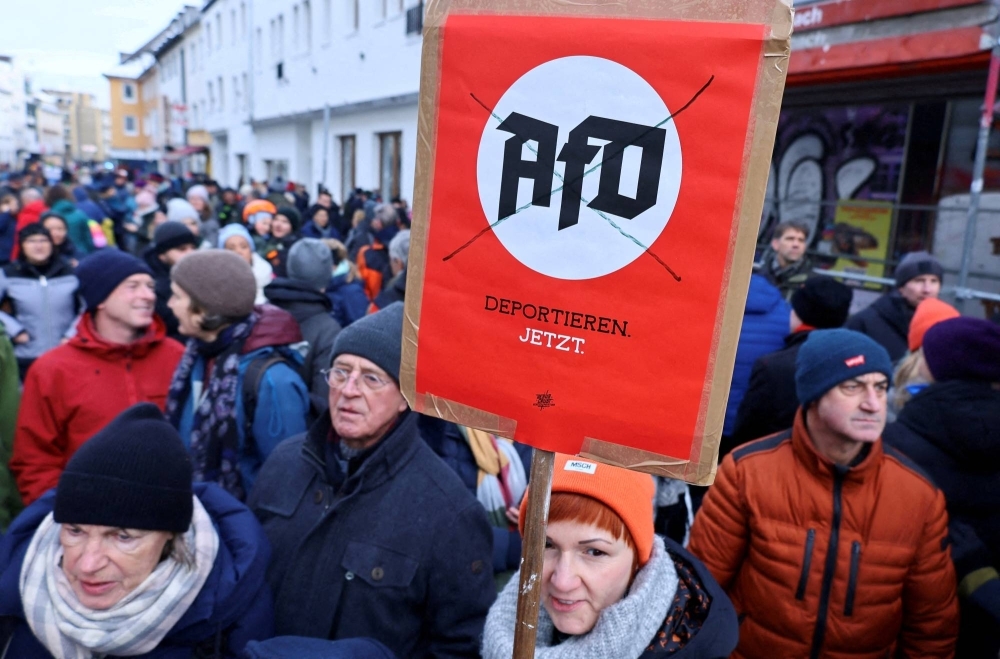 A placard reads, "deport AfD now," during nationwide protests against racism and plans of Alternative for Germany (AfD) party to deport foreigners, in Bonn, Germany.