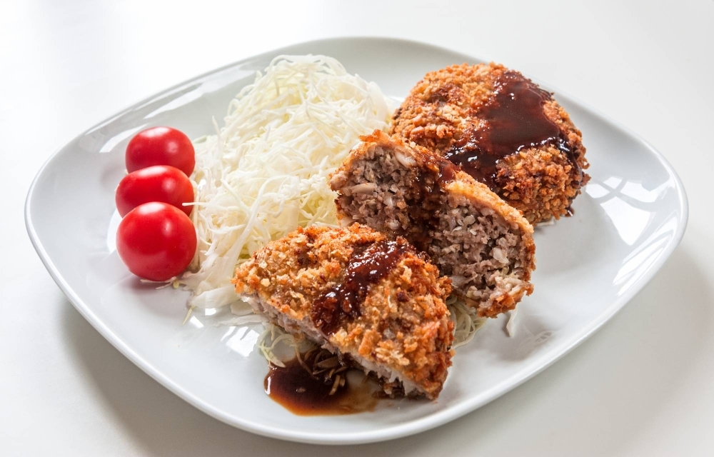 'Menchi katsu' are actually made with as much chopped vegetables as ground meat, so it’s a sneaky way to get some veggies into your childrens' diets.