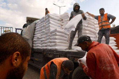 People distribute bags of flour to Palestinians in Rafah, in the southern Gaza Strip, on behalf of the United Nations Relief and Works Agency in November. The agency has come under fire after a few of its employees were accused of supporting terrorism.