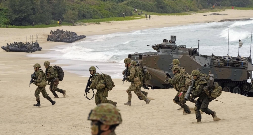 Ground Self-Defense Force members land using an amphibious vehicle on the shore of Tokunoshima island in Kagoshima Prefecture as part of large-scale joint drills with the U.S. Marine Corps in March 2023.