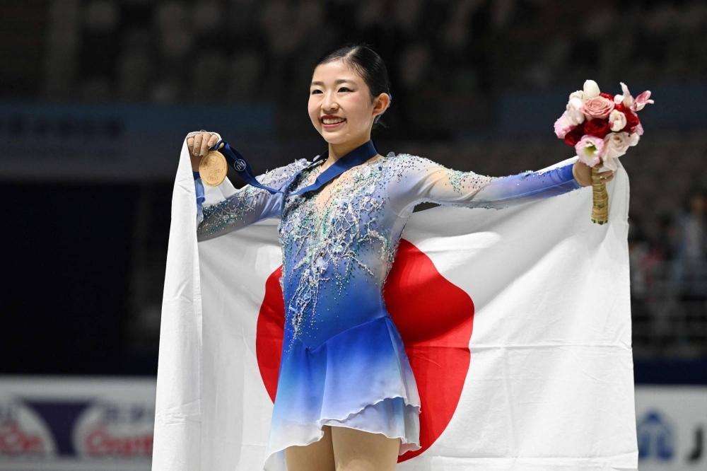 Japan's Mone Chiba celebrates after winning the women's competition at the Four Continents championships in Shanghai on Friday.  Japan's Mone Chiba celebrates after winning the women's competition at the Four Continents championships in Shanghai on Friday.