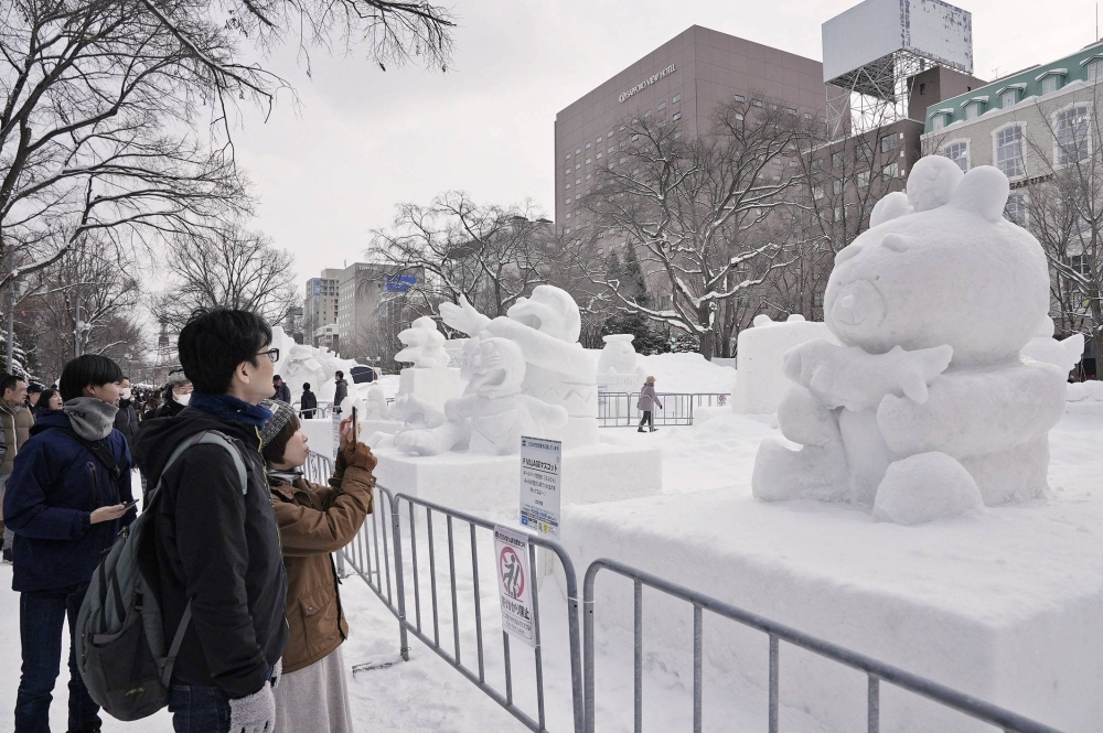 The annual snow festival opened in Sapporo on Sunday. The event, set to run through Feb. 11, features a total of 196 snow and ice sculptures at three venues, with food and drink areas set up for the first time since the outbreak of COVID-19.