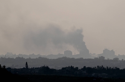 Smoke rises from inside Gaza on Sunday. Gaza health authorities, which do not differentiate between militants and civilians in their tallies, said on Sunday more than 27,300 Palestinians have been confirmed killed since the Israel-Hamas war began.