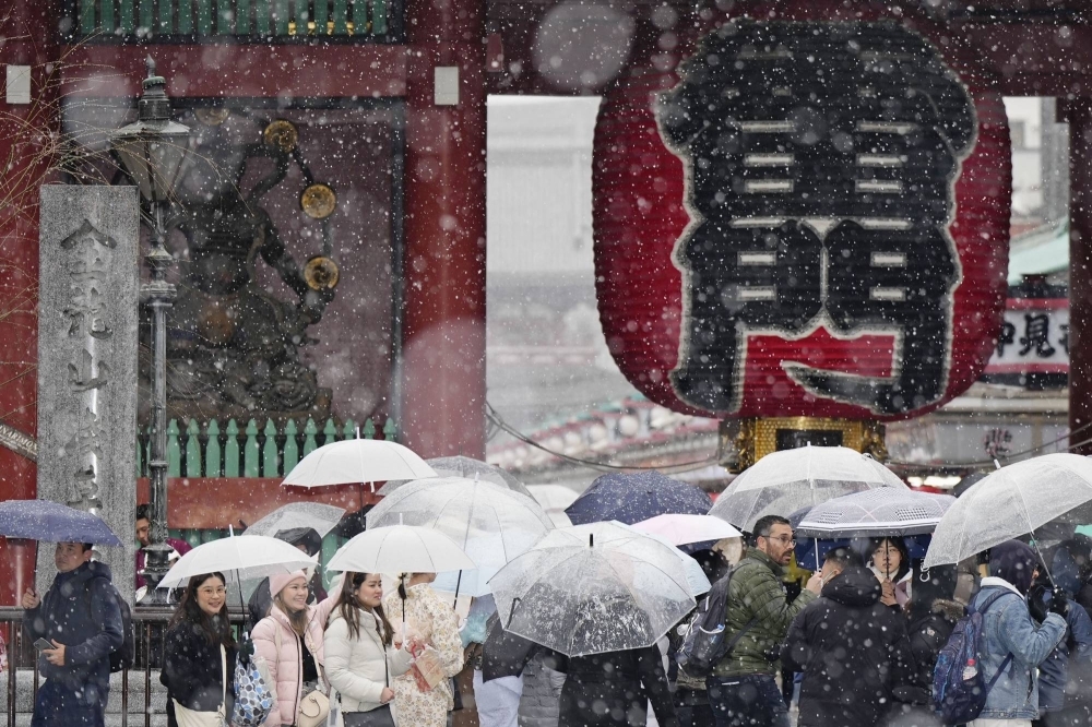 Snow falls outside Sensoji Temple in Tokyo on Monday.  