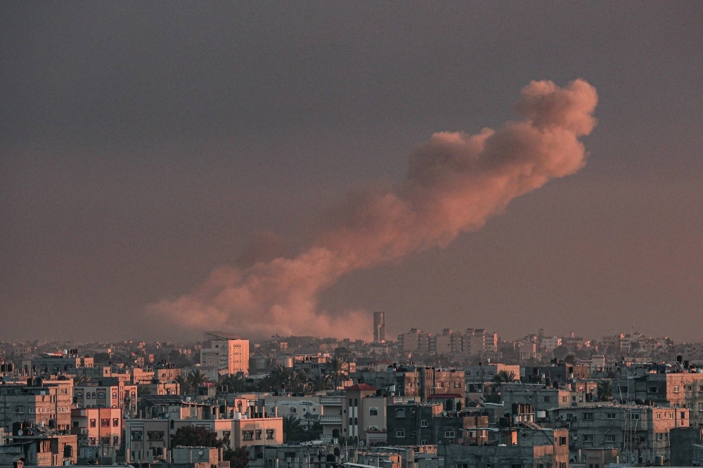 Smoke rises over buildings in Khan Younis in the Gaza Strip following Israeli bombardment on Monday.