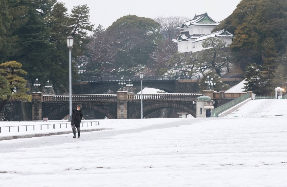 Areas around the Imperial Palace in Tokyo are covered with snow Tuesday morning.
