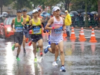 Naoki Koyama (right) runs en route to winning the Marathon Grand Championship men's race in Tokyo on Oct. 15, earning a ticket for Japan to the 2024 Paris Olympics. | Pool / via Kyodo
