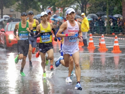 Naoki Koyama (right) runs en route to winning the Marathon Grand Championship men's race in Tokyo on Oct. 15, earning a ticket for Japan to the 2024 Paris Olympics.