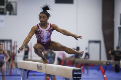 Simone Biles runs through a portion of her beam routine during the second day of a two-day media event with the USA Gymnastics team ahead of the 2024 Olympics in Katy, Texas, on Monday.
