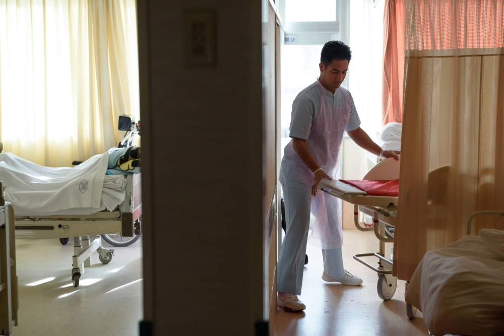 A Filipino care worker at a hospital in Tokyo. The inflow of foreign workers is set to continue at a fast pace as Japan seeks more assembly line staff, construction workers, vegetable pickers and caregivers for the elderly.