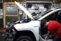 Workers install components on a RAV4 hybrid sport utility vehicle at the Toyota manufacturing plant in Georgetown, Kentucky. | Bloomberg