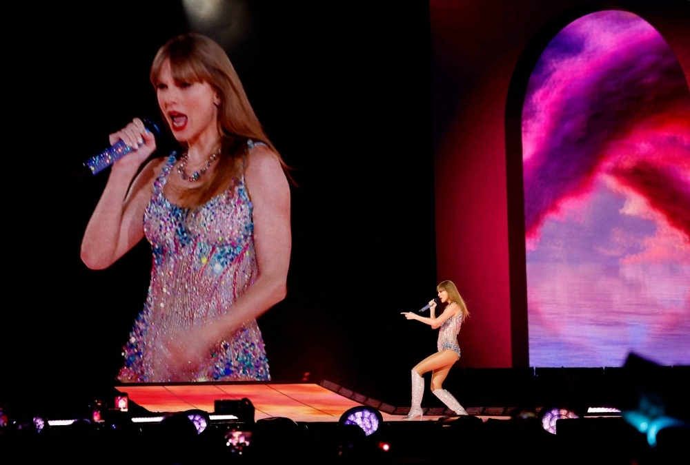 Singer Taylor Swift performs at her concert in Tokyo on Wednesday. With her winning her fourth Album of the Year at the Grammy Awards on Monday, sales of her merchandise will likely increase even as fans feel more compelled to purchase them for their premium value.