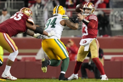 San Francisco 49ers quarterback Brock Purdy passes under pressure from Green Bay Packers defensive end Karl Brooks during a playoff game on Jan. 20. 
