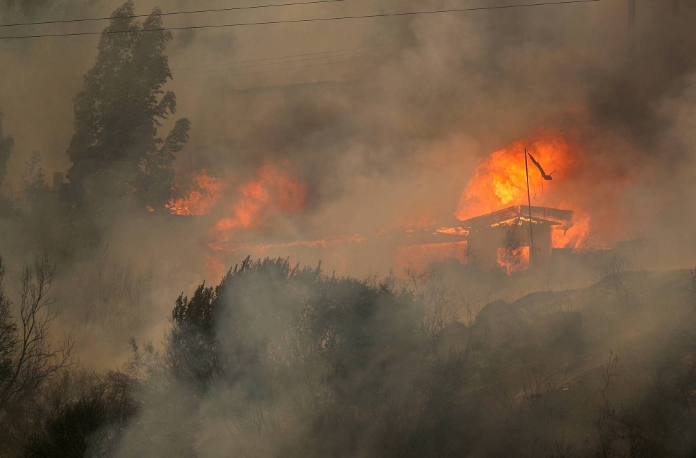 Houses burn amid the spread of wildfires in Vina del Mar, Chile, on Feb. 3.