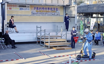 The Aichi Prefectural Police department holds an event in Nagoya in December to advocate safe electric scooter riding.
