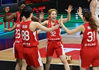 AFP-JIJI | 
Japan's players celebrate after the 2024 FIBA Women's Olympic Qualifying Tournament basketball match between Spain and Japan in Sopron, Hungary on February 8, 2024. (Photo by ATTILA KISBENEDEK / AFP)