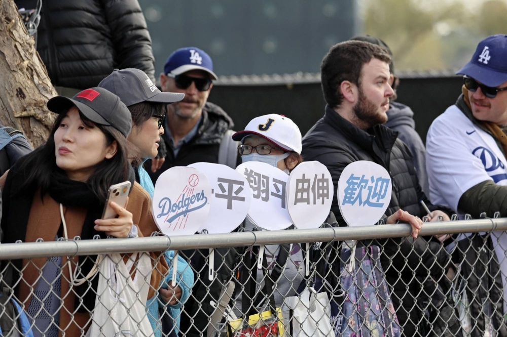 Fans of Shohei Ohtani wait outside the Dodgers' spring training facility in Glendale, Arizona, on Friday. 