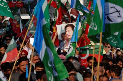 Supporters of the Pakistan Tehreek-e-Insaf party hold a portrait of former Prime Minister Imran Khan in Karachi, Pakistan, on Saturday. 