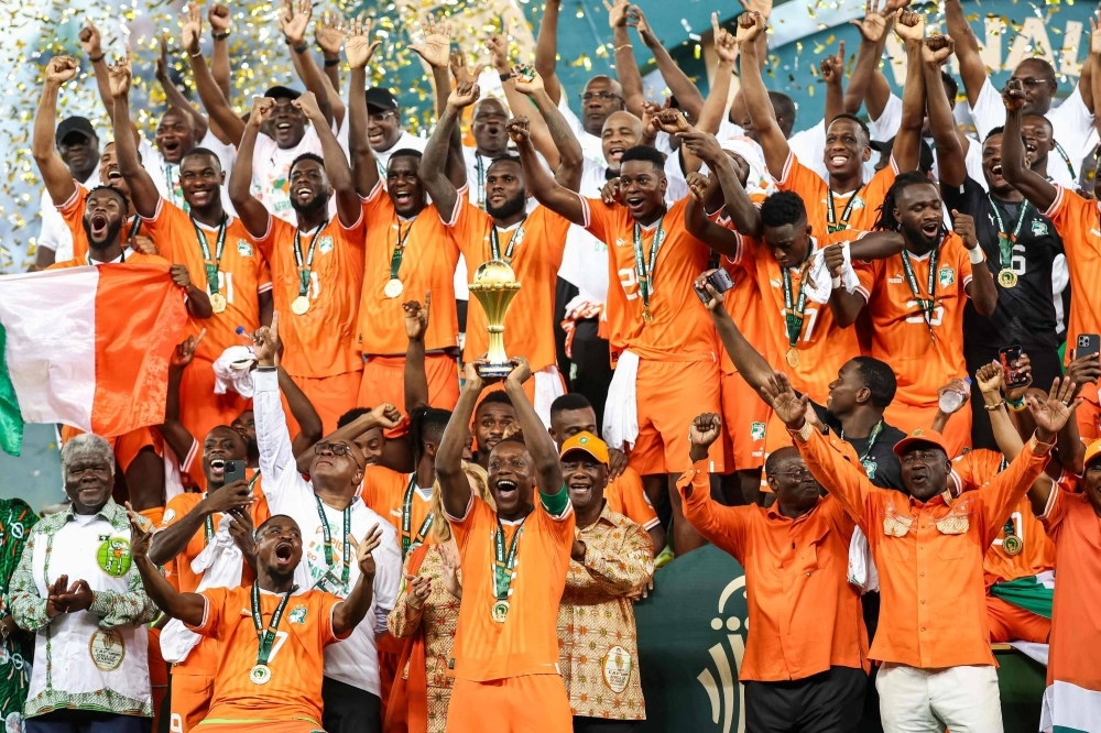 Cote d'Ivoire's Max-Alain Gradel lifts the trophy after the team's victory over Nigeria in Africa Cup of Nations final on Sunday
