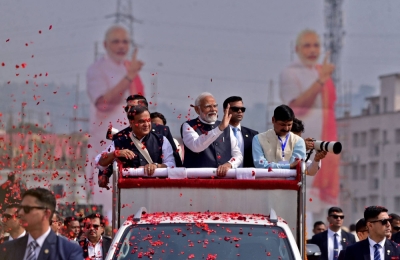 India's Prime Minister Narendra Modi waves to his supporters as he arrives at a rally in Guwahati, India, on Feb. 4.