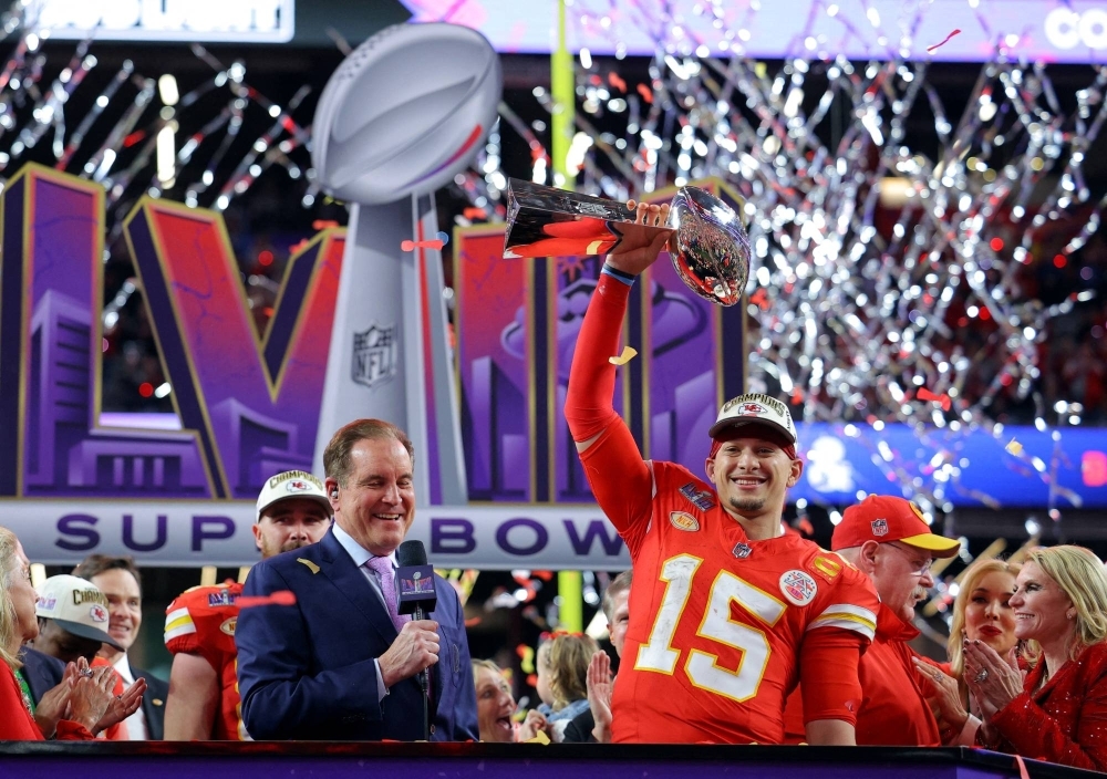 Kansas City Chiefs' Patrick Mahomes celebrates with the Vince Lombardi Trophy after winning Super Bowl LVIII on Sunday.