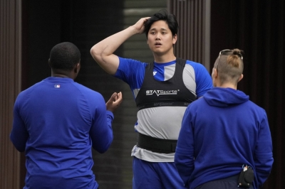 Los Angeles Dodgers designated hitter Shohei Ohtani works out with trainers during spring training camp in Glendale, Arizona, on Saturday.