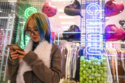 Wang Xiuting chats with her virtual boyfriend on Wantalk — an AI chatbot created by Chinese tech company Baidu, on her phone in Beijing.