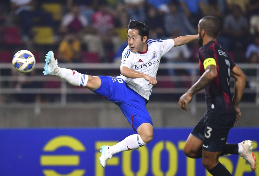 Marinos' Kota Watanabe jumps to kick the ball against United in the first leg of their Asian Champions League match in Bangkok on Wednesday.