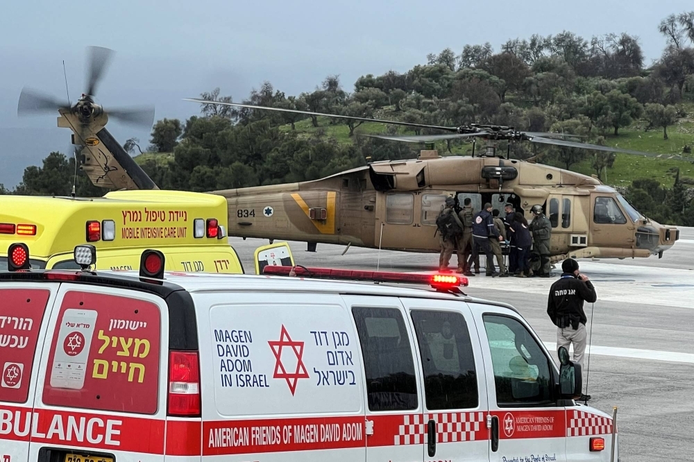 Israeli officials evacuate a person who was injured by a rocket fired from Lebanon, in Safed, northern Israel, on Wednesday.