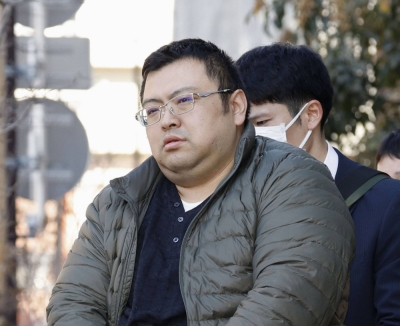 Kenichi Hosoya leaves his apartment in Tokyo's Taito Ward on Wednesday after being arrested.