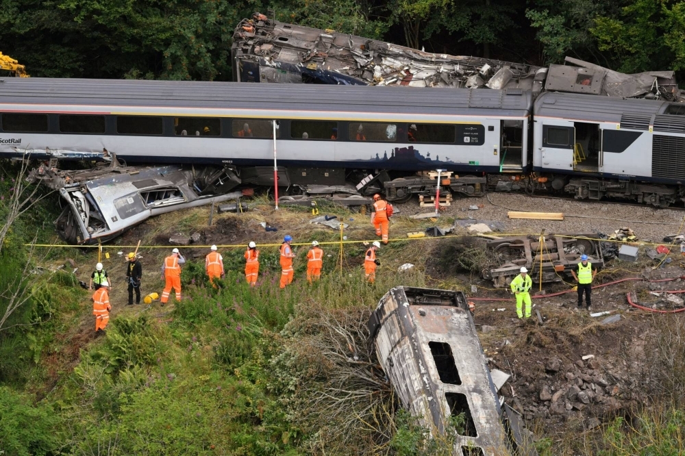 Emergency services inspect the scene following the derailment of the ScotRail train near Stonehaven, Scotland, on Aug. 13, 2020.