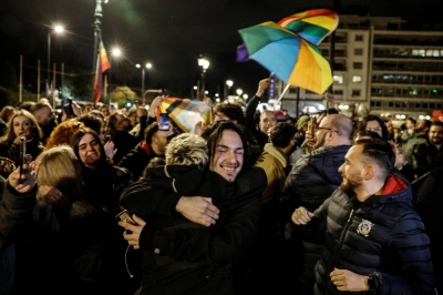 Members of the LGBTQ community and supporters celebrate in front of the Greek parliament, after a vote in favor of a bill that approved allowing same-sex civil marriages, in Athens on Thursday.