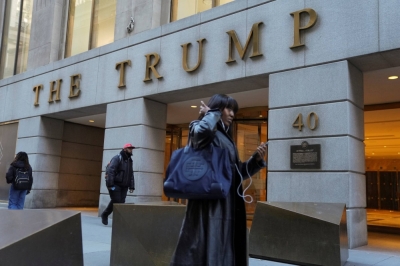 People walk past the Trump Building after a ruling against former U.S. President Donald Trump ordering him to pay $354.9 million and barring him from doing business in New York state for three years, in New York City on Friday.