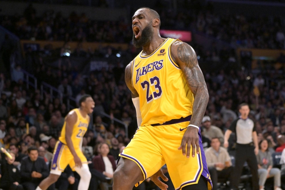 Lakers forward LeBron James celebrates after a dunk against the Pistons on Tuesday. 