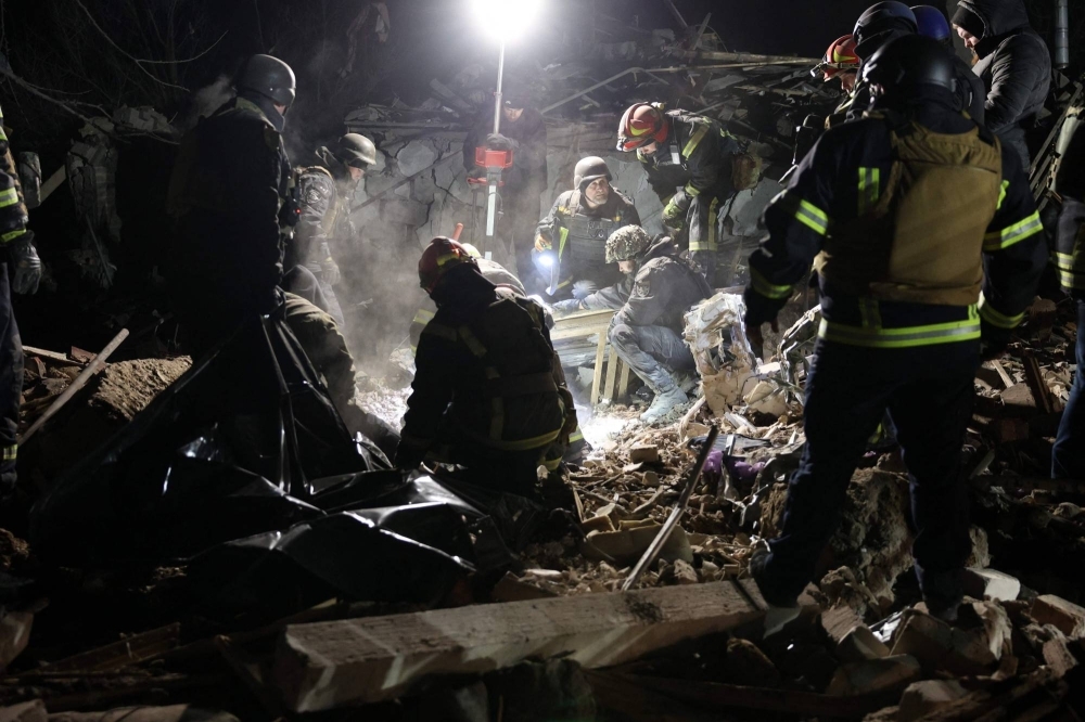 Ukrainian police officers and rescue workers clear away the rubble of a destroyed house after a Russian rocket attack in Kramatorsk, Donetsk region, on Saturday.