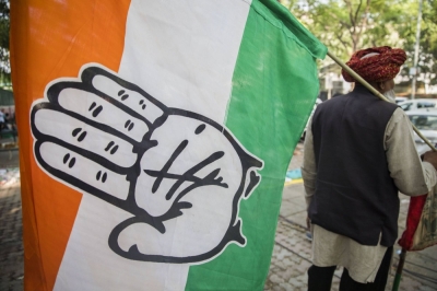 A supporter carries an Indian National Congress Party flag outside the party's headquarters in New Delhi in 2019.