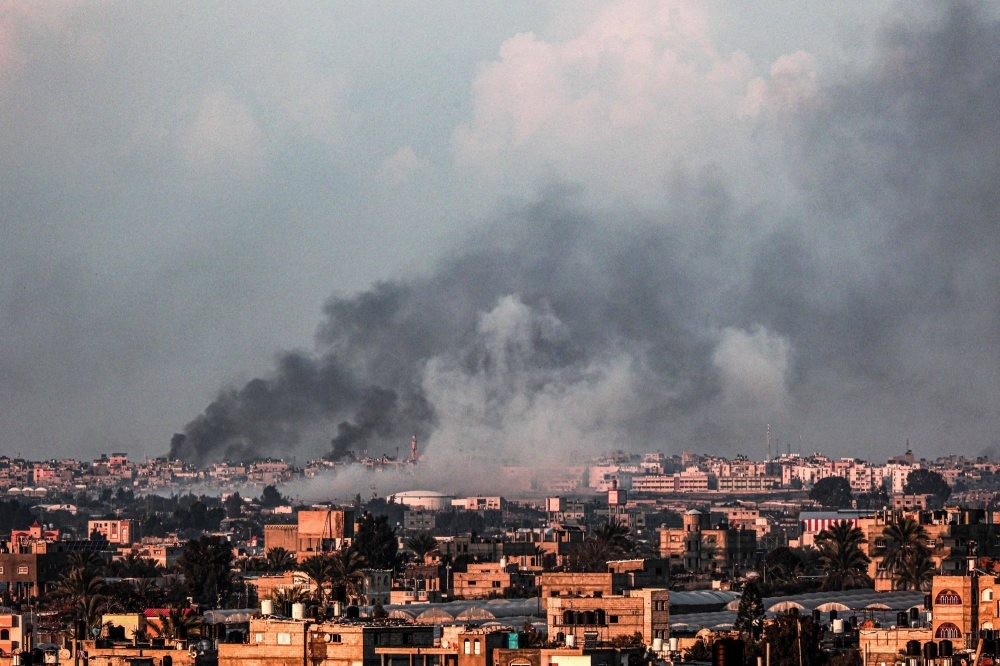 Smoke billows over Khan Yunis in the southern Gaza Strip during Israeli bombardment on Sunday.
