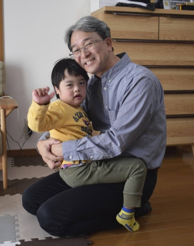 Hiroki Matsubara (right) and Yamato, who has Down syndrome, are pictured in Nara in November. Matsubara founded Migiwa, which aims to protect unwanted babies and help place them with new families through plenary adoption.